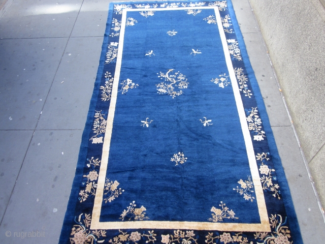 An antique Peking carpet in a very rare gallery format,with a mostly open luminous royal blue ground.The wool is glossy with a desirable patina.There is slight carving to further emphasize the design  ...