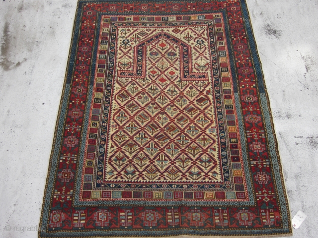 Antique Caucasian Daghestan Prayer Rug , Last Quarter 19th Century 5.10 x 4.3
The ivory ground with a sawtooth lozenge lattice enclosing various colourful flowers in an allover "V' effect is classic Shirvan  ...