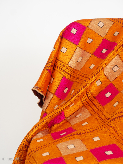 Orange and Pink Phulkari Bagh Early 20th Century

Punjab, early 20th Century circa 1920s/30's. 228cm x 132.5cm cm (89 x 52 inches). Densely embroidered with six and a half rows of large lozenges, latticed in the most  ...