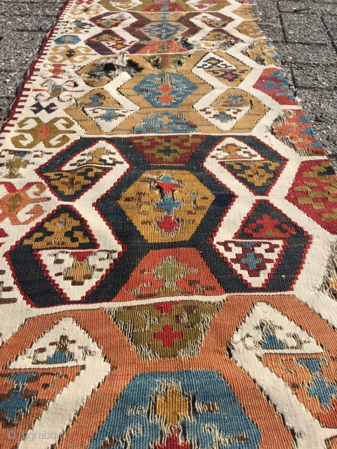 Early Anatolian hooked kilim, one wing. Clean, very good colors (purple, apricot, nice greens), good condition for it's age. Interesting use of dark hooks as partitioning elements, creating a rhythm throughout the  ...