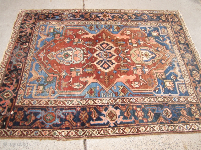 antique serapi heriz rug measuring 4' 11" x 6' 2" condition as shown one hole area of wear and scattered moth issue generally a good pile has been cleaned ends need work  ...