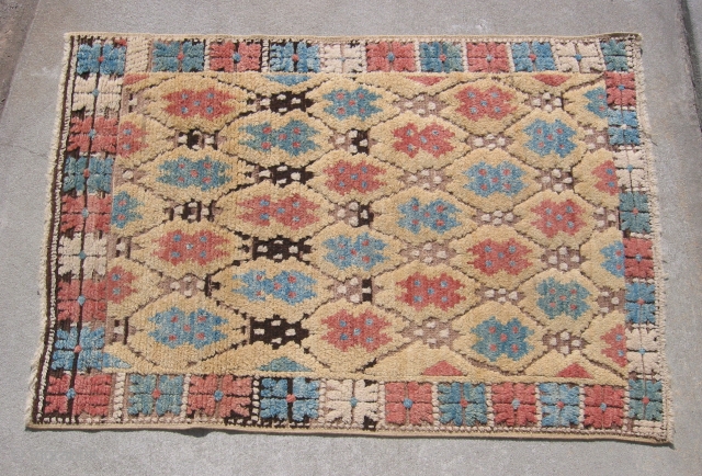 Antique yellow ground Konya rug, hand knotted wool, Central Turkey, 1st QTR 20thC, rose, blue, strong condition with no holes or repairs, the ends and sides are intact, the abrash of black/brown  ...