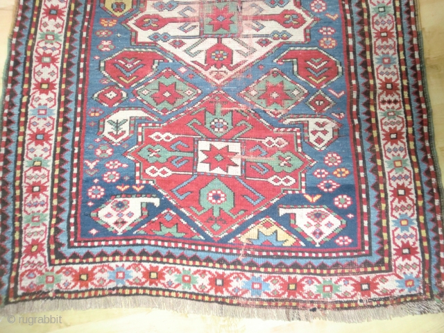 Pleasant Kazak. Good range of colours. Abrash. Interesting design. Slight losses one end, wear in the field in places and sides secured. But still bright and decorative. 199 by 100cm   