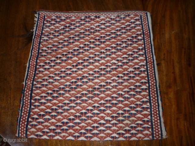 Sweet little Turkoman bag in white goat hair. All over motifs on front and back in red, rust and indigo. The second photo is the reverse. 36cm square. Couple of small repairs  ...