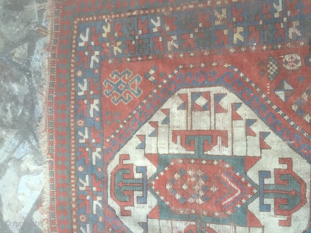 Pleasing kazak rug. Late 19th century with good abrash and asymetrical icons. Has a charm. Few small holes, small stain, tear on one end but pretty much untouched. Needs a good clean.  ...