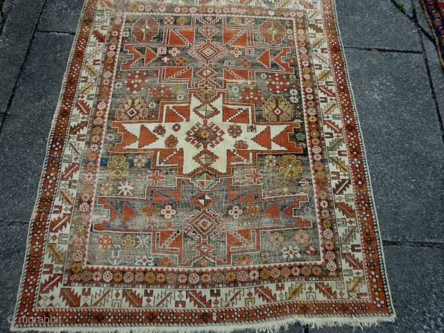 Caucasian lesghi design. Heavily corroded field. Still good enough for the floor. 126 by 164cm. Going Cheap                