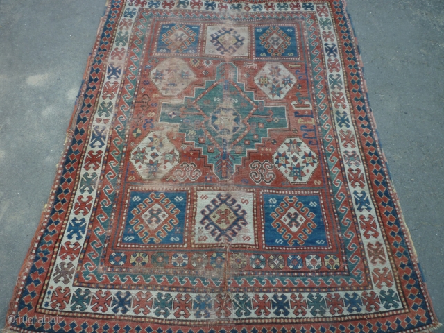 19th century kazak. Couple of tears and some wear but some good colours and appealing design elements. 188 by 139 cm. ask for more photos if you want.     