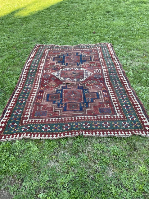 Dirty bashed up Kazak. Couplw of holes, rips and tears bur great colours and design. Ans despite its issues a great rug. Turkish repair special? 7 x 5 feet    