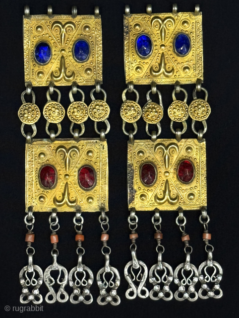 Turkmen - Yomud tribal pair of silver hair jewelry with dangles. It has orginal patina with coral and gemstones. There is a gilded plate, This also gives it a richer appearance. In  ...