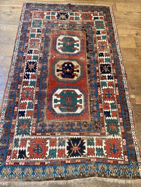 Pre commercial kazak probably mid 19 c with unusual design and the saturated natural dyes we would expect from that age. 
Size 232 x 136. Hand washed old repairs to corroded brown  ...