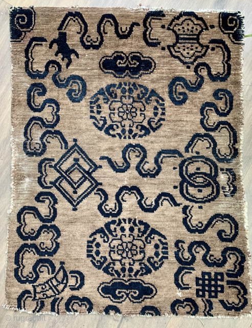 AntiquecTibetan rug with good age ca1880 or before.  the double squares are Chinese double lozenges(Fangsheng) and the two circles, double coins( Shuangqian), and not so sure about the top right motif  ...