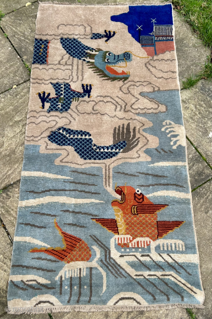 very unusual vintage Chinese rug with fish and dragon size 200 x 80 cm excellent condition just washed.  The fish has decided to eat the whole cloud where the dragon is  ...