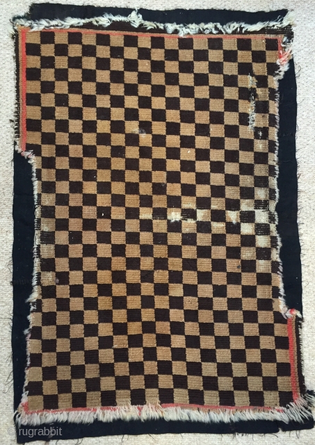 Nice genuine antique Tibetan chequerboard rug early 20 c.
Cute small size remnants of synthetic red borders to all four sides.
Needs backing properly but has great movement       