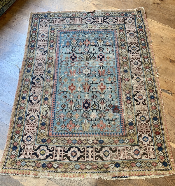 Early shirvan rug with powder blue field and Kufic border ca 1820 one old patch and darning to the corroded brown 
Not many rugs  this old on the market.    ...