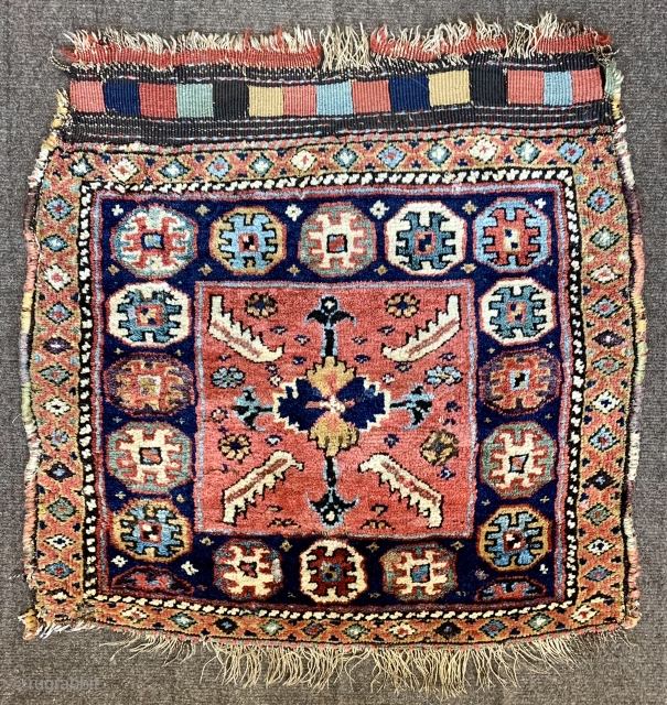  here is a rare early kurdish saddle bag face from the mid 19 c.  Just look at those colours!  Full thick pile but some old repairs nibbles and moth  ...