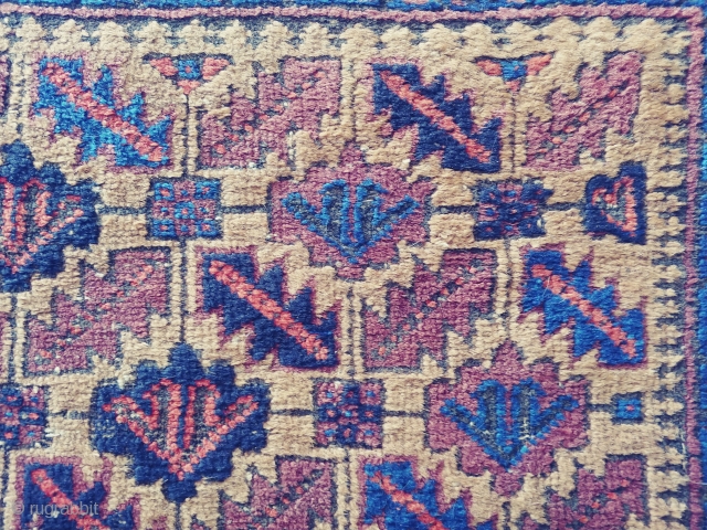 Antique Camel ground Baluch. Not a very common form of the ashik gul found in Baluch rugs. Nice grid work and notice how the arrows inside the guls point in one direction.  ...