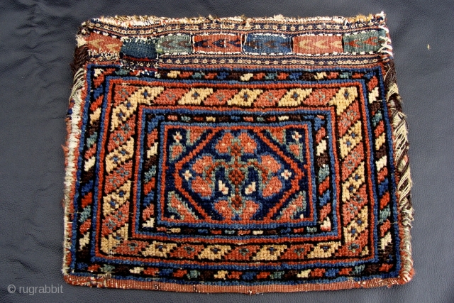 Tiny Kurd bag or Chanteh. Unusual single clover leaf type design in the medallion along with three striped borders and fine kilm closure tabs with chevrons at the top.  11 inches  ...