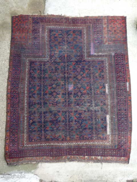 An ancient and venerable blue field Timuri prayer rug. Inky black field with polychromatic light blue and green. Low pile faded old repairs etc. Beautiful old rug. 4ft10ins. x 4ft   