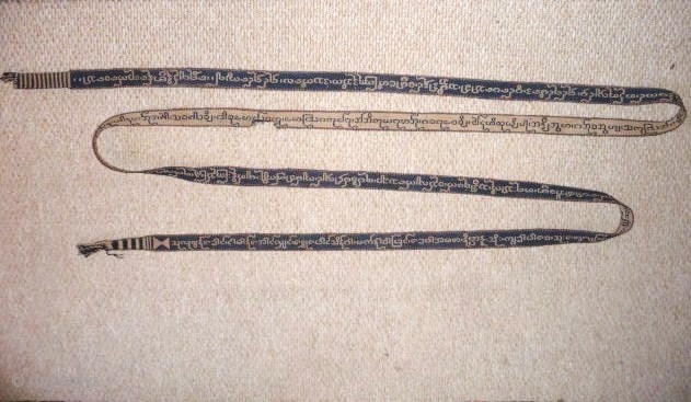 Burma, 19thcent. A beautifully woven cotton band used for binding sacred texts 10ft x 1ins.Excellent condition apart from small damaged area in the centre.         