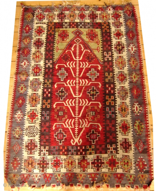 A late 19th Century Central Anatolian (Kayseri) Prayer Kilim.

Size 108 x 159 cm.

Good colours, in overall fair to good condition, minor stains and repairs, end borders frayed.      
