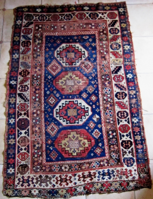 
A 19th Century Memling-gul Kazak

Size 133 x 202 cm

Great colours, including aubergine, pale green, yellow, two reds and two blues
Interesting borders with a naively drawn 'crab border' at one end. Pile is  ...