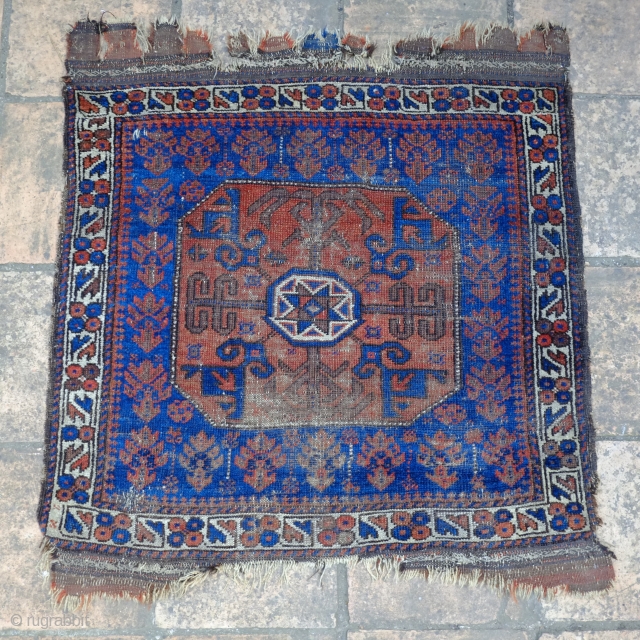 A Baluch Star in Octagon Khorjin/Bag-Face from the second half of the 19th Century

Dimensions Height 71 cm Width 77 cm

In fair overall condition with localised heavier wear in the lower field.
It has  ...