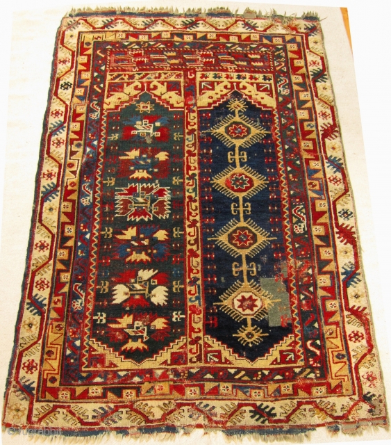 Mid-19th Century Makri/Megri two panel rug size 198cm x 135cm.

Fabulous colours including an unusual dark-blue green in one panel and two yellows. Wear, repairs, the rug is largely intact. Kilim ends have  ...