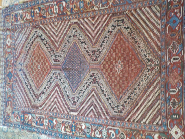 Attractive antique Khamseh with vibrant colours. Partially low pile and a small area with a reparation and a very small hole (see last two photos). Size is 220 x 153 cm.  