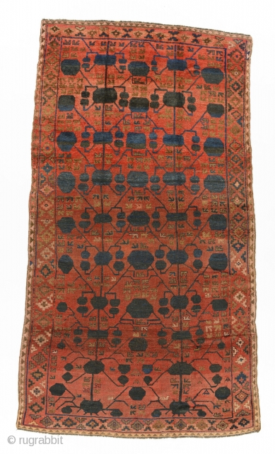 Kyrgyz giliam, Ferghana, Central Asia, late 19th century, 360 by 206 cm, an exceptionally rare for Kyrgyz carpets pomegranate design (Kashgar nuska) borrowed from Chinese Turkestan's silk carpets, natural colours, signed LR  ...