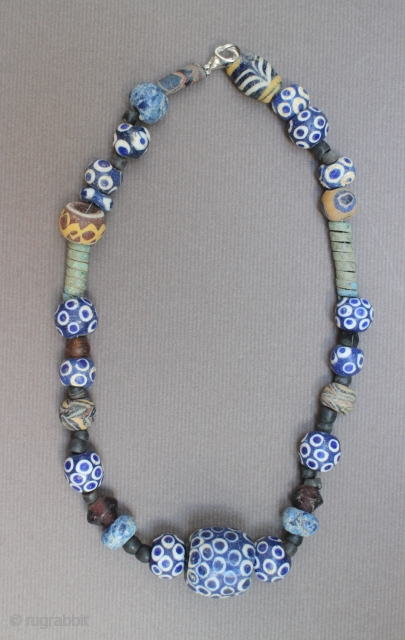 Ancient mosaic glass, stone and bronze necklace, 2nd-1st centuries BCE, Asia Minor, restrung with modern clasp, 41cm long.               