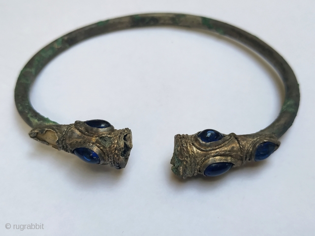 Ancient silver bracelet with lion heads, 2nd-1st century B.C., Near East, inlaid with blue glass, diam. 7.5 cm               