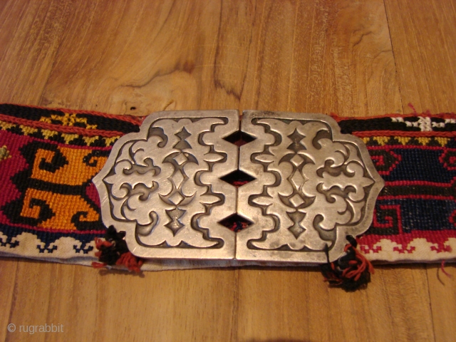 Embroidered belt with silver buckle.                            