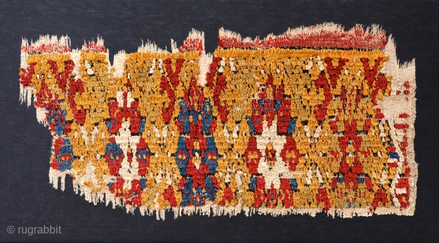 A beautiful Turkish fragment of a yatak. Fantastic shades of colour. Many centuries old. About cm 70 x 25. Conserved and fixed on a rigid panel.       