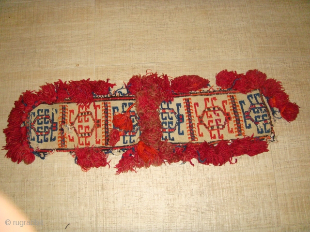 Late 19th to Early 20th Century Decorative Turkmen Camel Neckband Trapping. Red-Orange and Blue Soumakh - weave designs on White Flatweave Base. All Wool.
Dimensions: Length: 84cm  Width: 22cm (Length inclusive of  ...