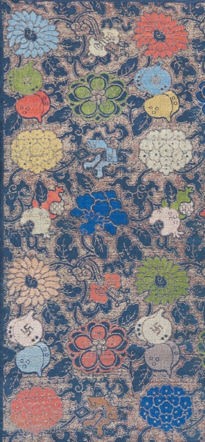 A Ming dynasty textile fragment with incredible color and a bevy of Chinese symbols dispersed throughout it's two layered design. The top design is done in silk brocade, while the underlying design  ...