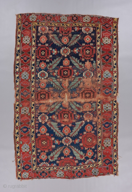 Kurdish serrated leaf lattice rug. A very early one of it's type in a rare size. Relatively restrained yet gorgeous color palette. All original in challenged condition, but the beauty remains !!  ...