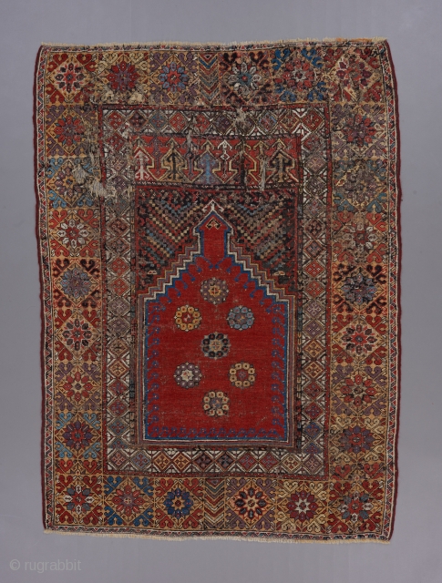 18th century Mujur prayer rug . 5'7" x 4'. Great color and classic design . Small repairs scattered throughout .             