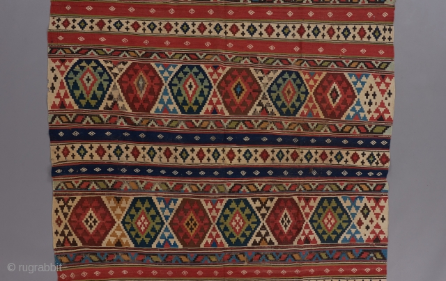 Caucasian kilim with spectacular colors.The White diamonds on the plain blue and red stripes are embroidered. An exceptional one of its type. 11'2" x 5'4".        