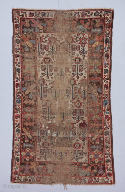 Circa 1800 Kurdish rug with a beat up but beautiful field of three different flower forms. Great scale in the drawing. 6’8” x 3’10”.         