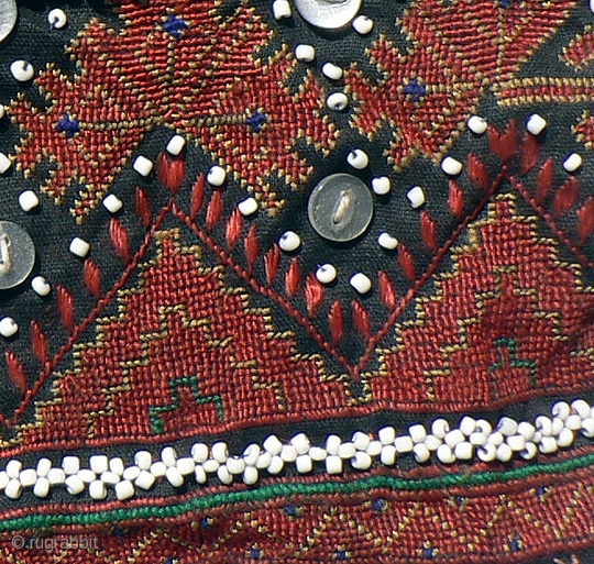 Indus Kohistan Child's Vest. Finely embroidered in tiny cross stitch and flat stitch, with intricate beadwork, baubles and buttons, demonstrating the mother's skill and love for her young child.  Early to  ...