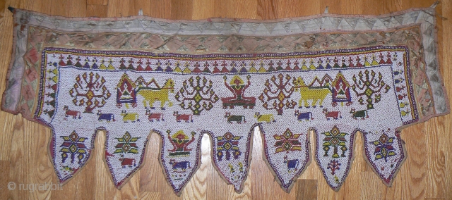 Beautiful old beaded toran from Gujarat, India. Nice old toran made of thousands and thousands of tiny beads strung together to make images of cows, flowers, bullock cart pulling shiva, etc. Satiny  ...