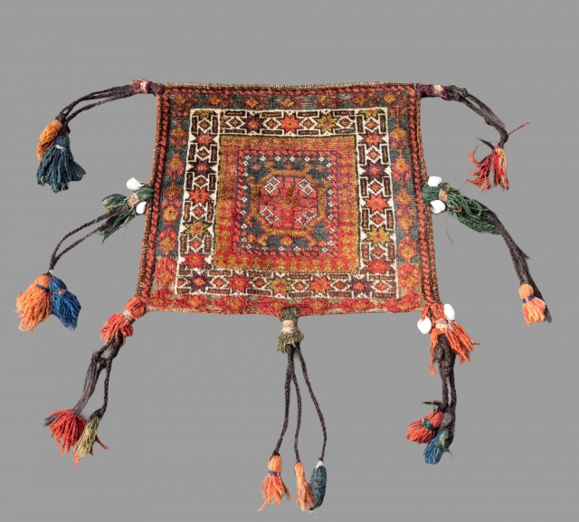 Antique Baluch double faced  bag with original long tassels.The  bag is in excellent condition with very slight even wear and good pile. 
Circa 1900       