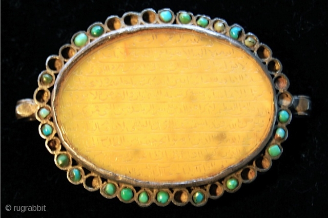 BAZUBAND,
Moghul, India,17th Century,
Large oval yellow Agate with inscription of Koranic Verse 'Ayat ul Kursi' mounted on silver in Naskh script.
Please ask for etails          