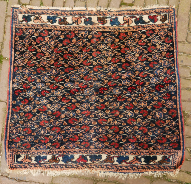 Afshar poshti? small rug, floral design,  75 x 75 cm. not quite square and some moths, signs of use, and the orange has softened, although the colours look good to me.  ...