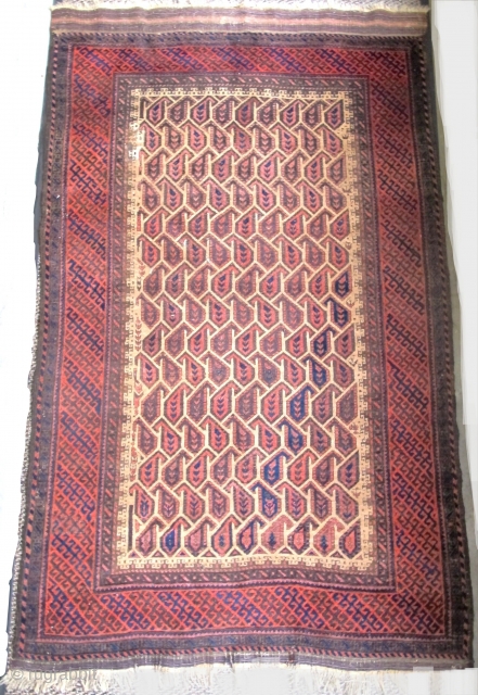 Very graphic camel ground Baluch rug with unusual geometric botehs arranged in a subtle but sophisticated repeat, creating diagonal negative space that works very well with the diagonal latch-hook striped border. The  ...