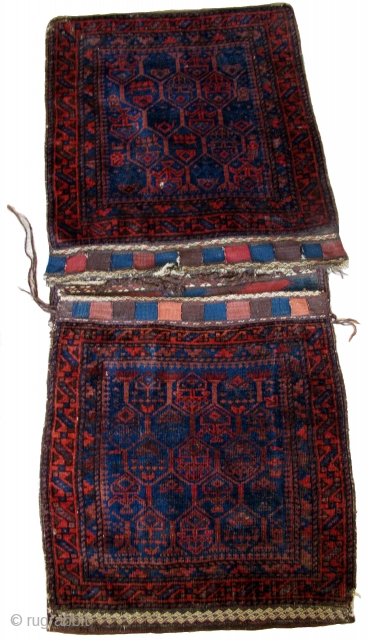 Complete Timuri type Baluch Khorjin Saddle Bag Set. The sides have been opened but the entire piece is complete and in great shape with both bagfaces, flat-woven fasteners and kilim bridge. Super  ...