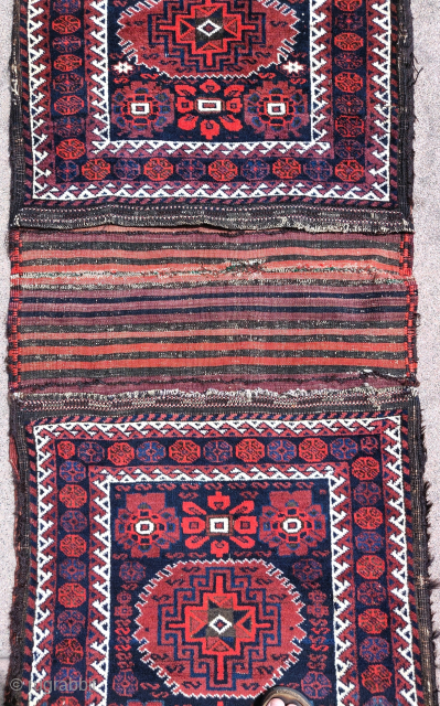 Complete Baluch khorjin with a very unusual design integrating minakhani flowers with a central Memling medallion. All good colors and in good condition. Probably Torbat-i Jam, circa 1880.  Very rare and  ...