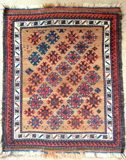 Small camel ground Baluch rug with floating diagonal elements excellently spaced, rustic construction with camel, wool and brindled warp, striped kilim on both ends. distinct band if abrash towards the bottom of  ...