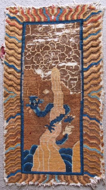 Chinese Rug with Dragon coiled around magic mountain reaching into the clouds. Fantastic iconography with clouds and phallic mountain jetting out of the sea. Not ancient but very fun, probably Deco period.  ...