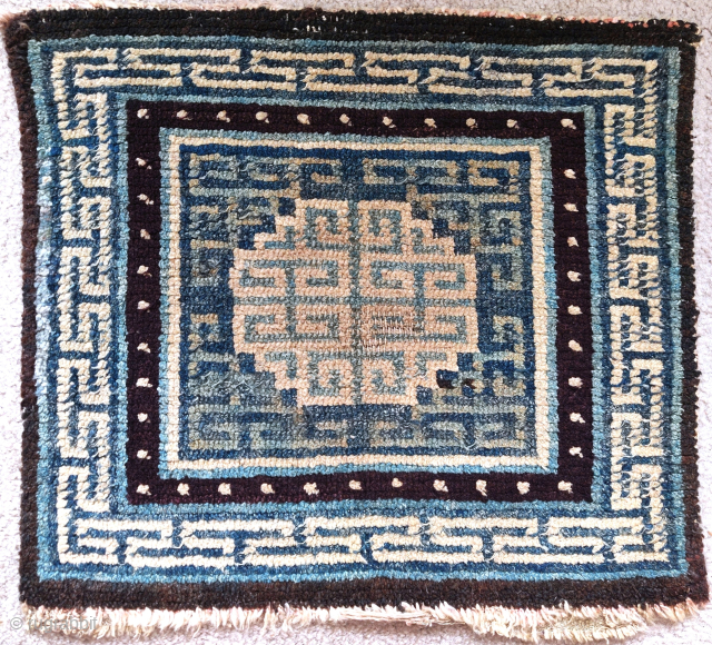 antique Tibetan square, several indigo blues and intriguing integration of the corner-pieces with the central medallion, 61x56cm